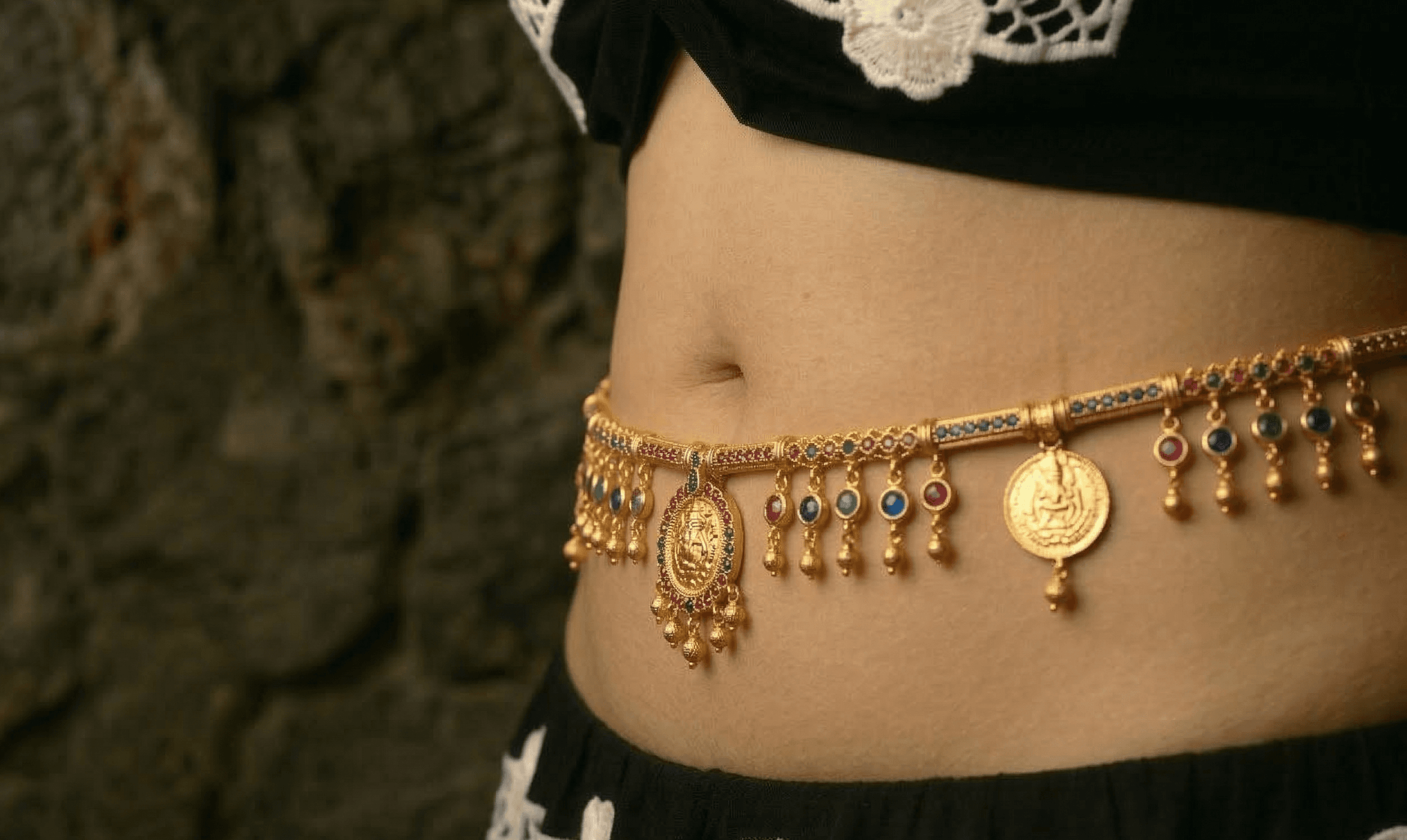 Traditional gold kamarband on South Asian woman